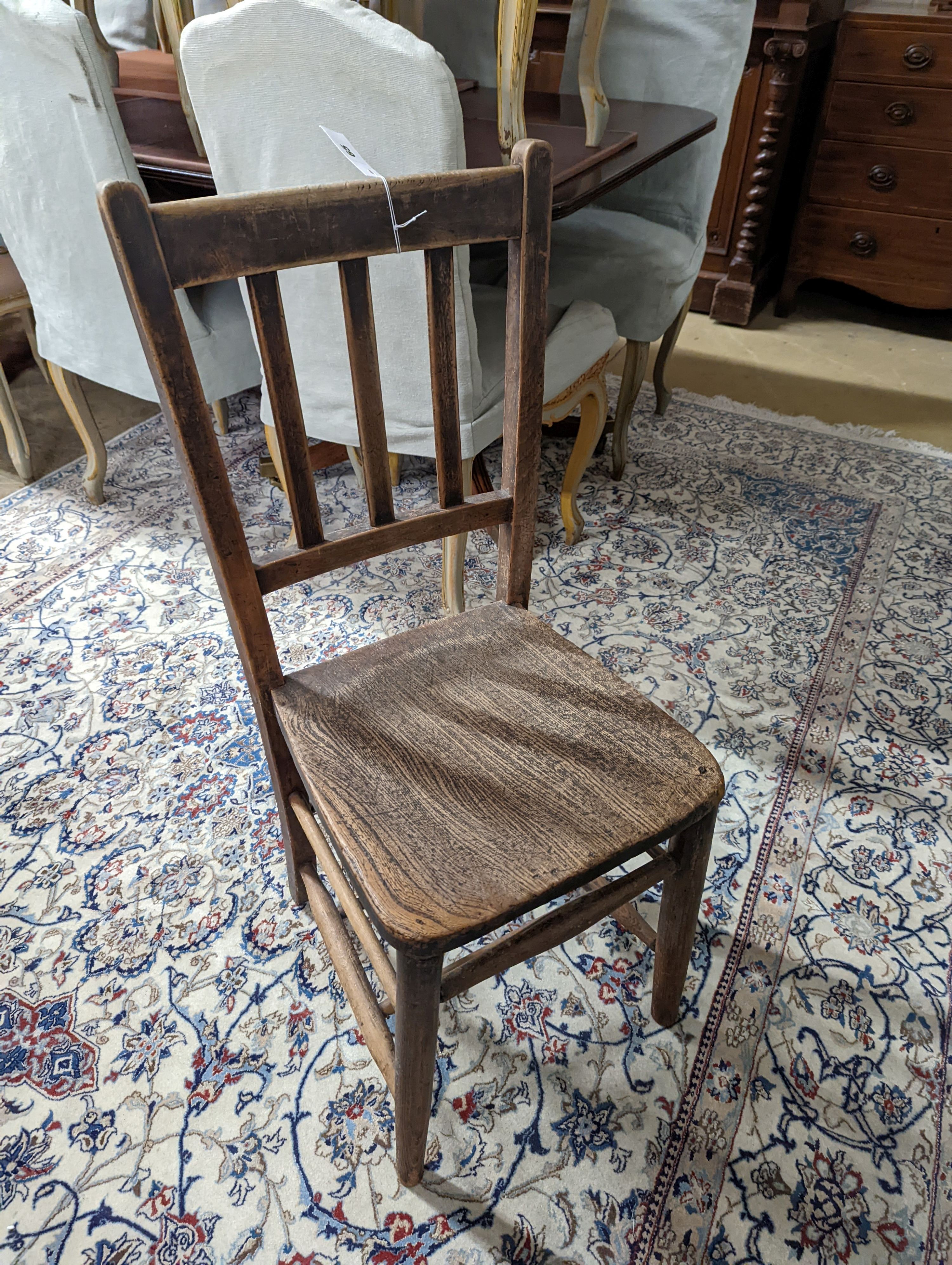 A vintage oak student's desk, width 57cm, depth 46cm, height 71cm with a beech and elm chair